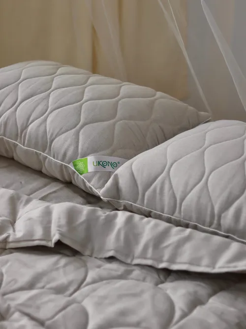 Natural bedroom textiles, blankets, and pillows by UKONO brand